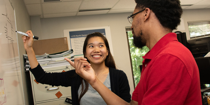 Employees discussing design implementations