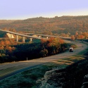 Truck driving rural highway near sunset