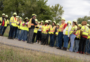 Professionals employees wearing personal protective equipment engaged in training.